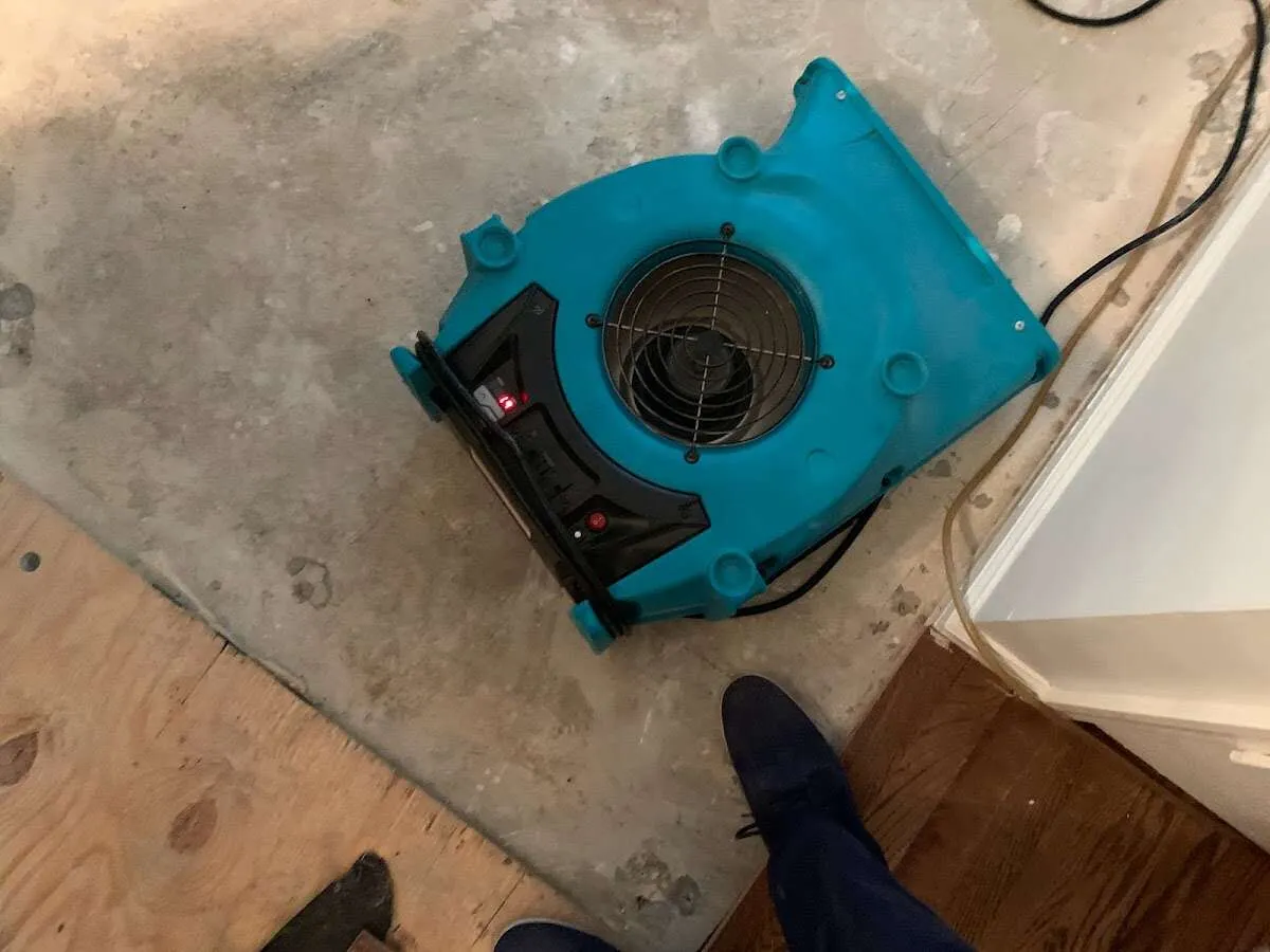Air mover drying subfloor during Commercial Water Damage Restoration in Old Jamestown